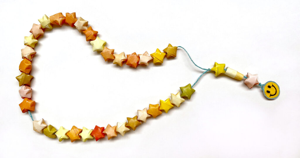 image of star-shaped paper worry beads looped on string