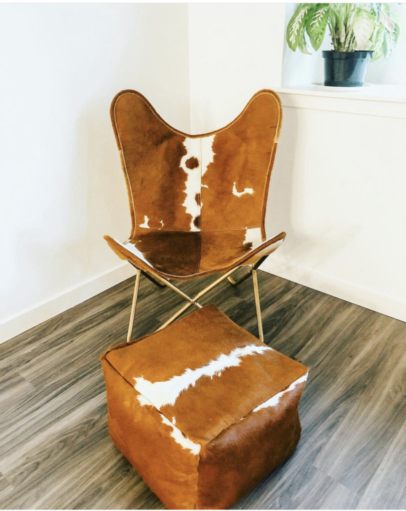 Hair-on hide butterfly chair and cube-shaped ottoman in white and tan, designed and made by Treasure of Nikki&Mallory