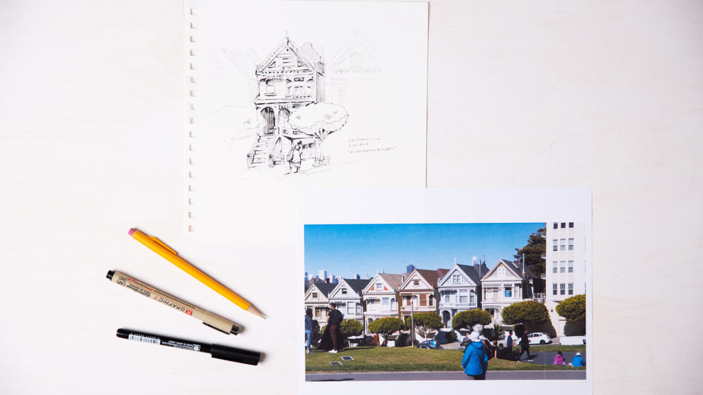 Flat lay on white background of a photo of the Victorian houses in San Francisco next to a sketch of a house and tree