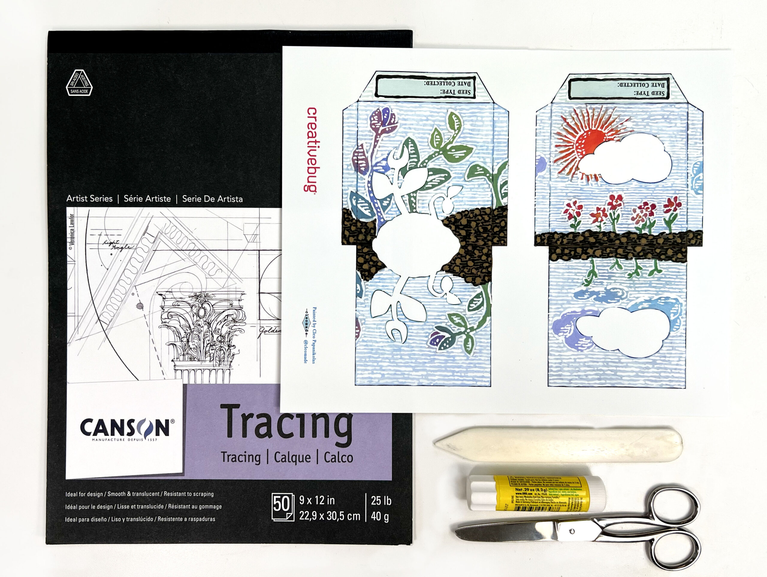 image of materials needed to make handmade paper seed packets including a paper template, scissors, bone folder, glue stick, and tracing paper