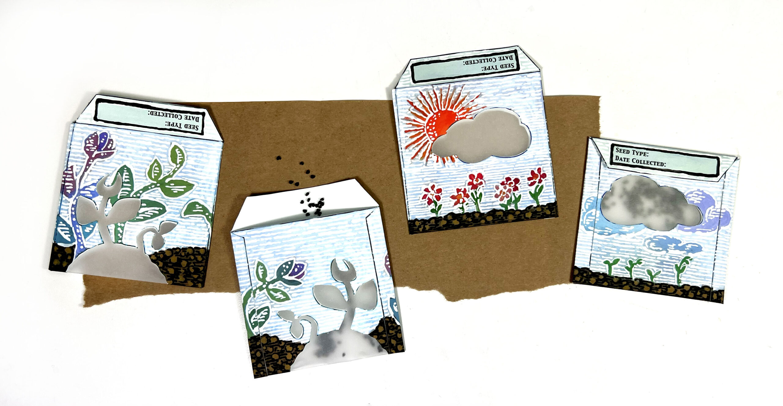 image of 4 handmade paper seed packs with hand painted floral designs on them