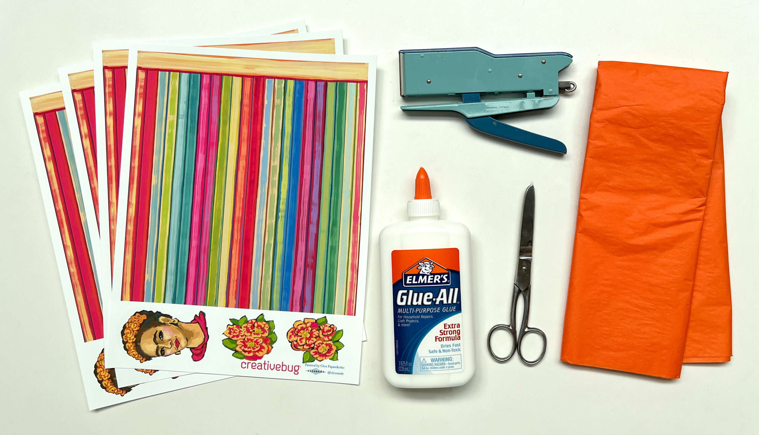 image of materials needed to weave a bag out of paper: free printable templates with original artwork of frida kahlo's portrait, stapler, elmer's glue, scissors, and colorful tissue paper