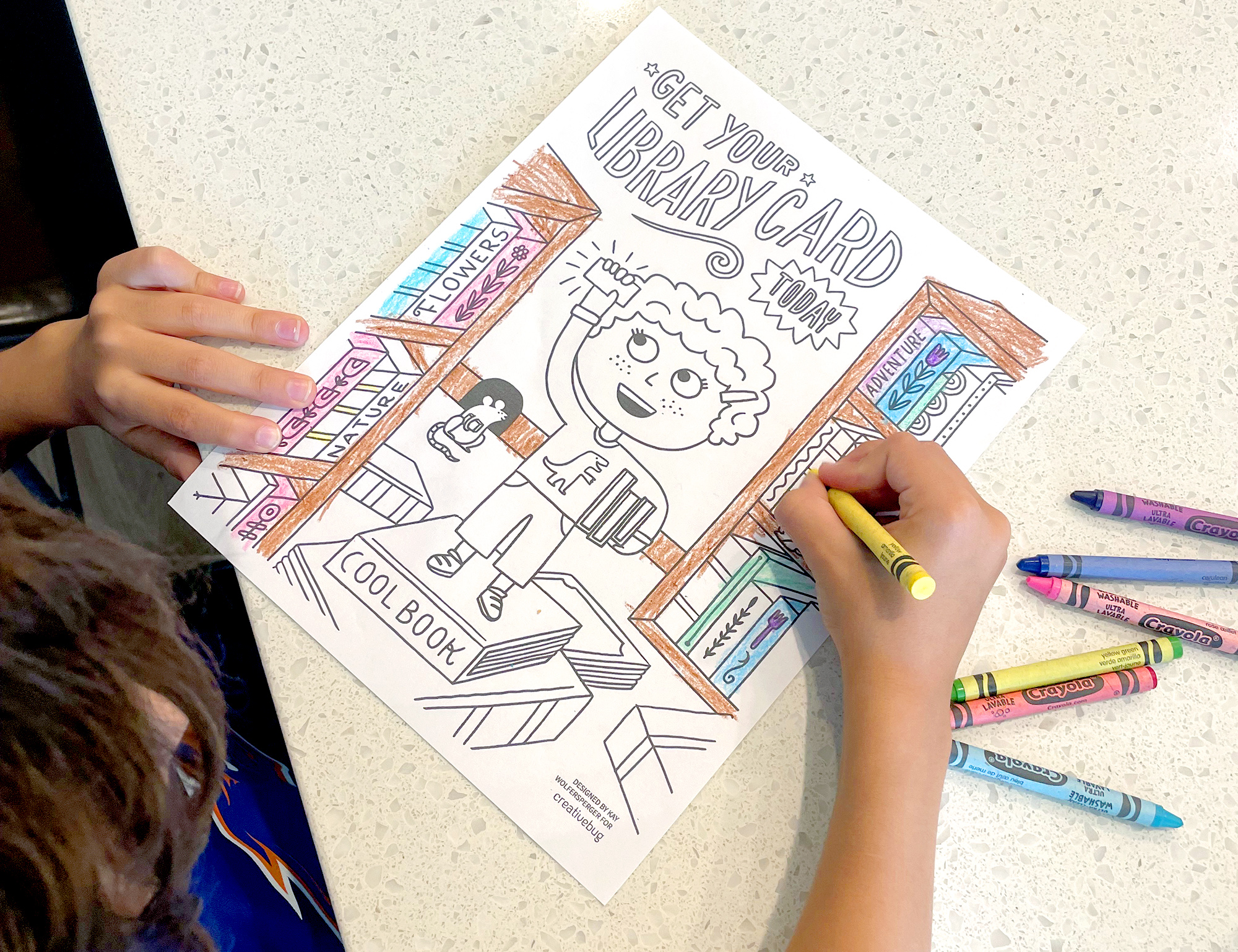 image of a child coloring in library card coloring page with crayons