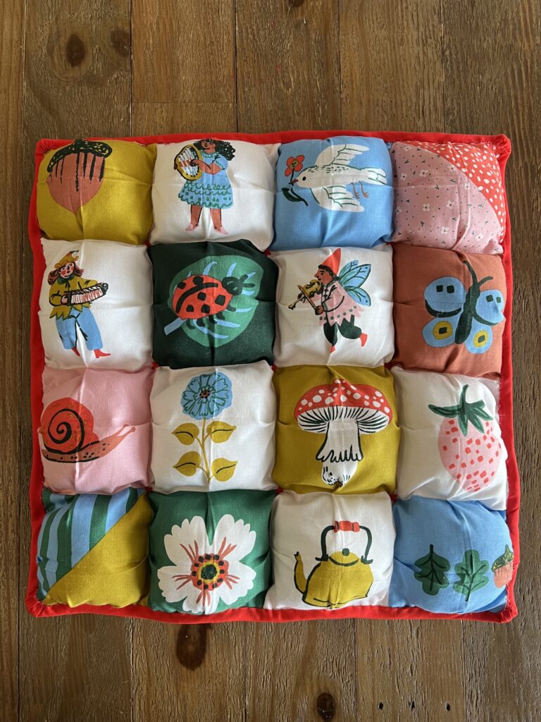 small square puffy quilt featuring fairytale characters