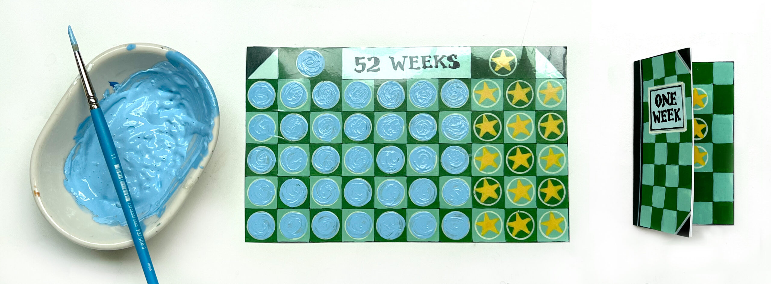 image of a dish of light blue paint and paint brush on the left and two pieces of printable art with green grids representing weeks of the year to make a scratcher card