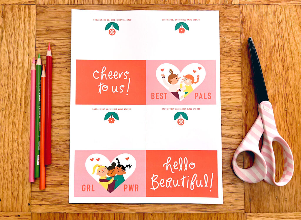 image of materials needed to make a cute Galentine's Day printable card: print-out of PDF artwork, scissors, and colored pencils