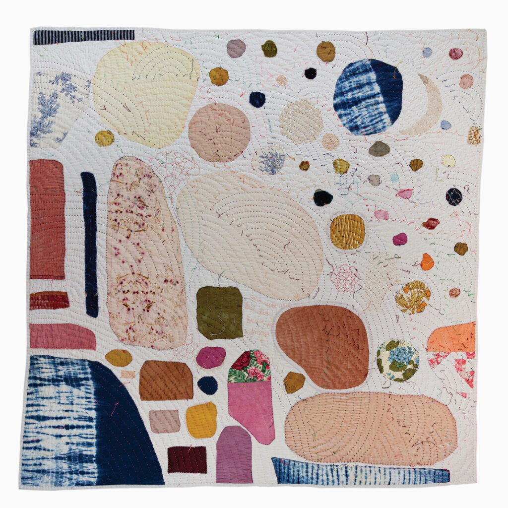 images of handmade quilt with many colorful round patches and visible hand stitching