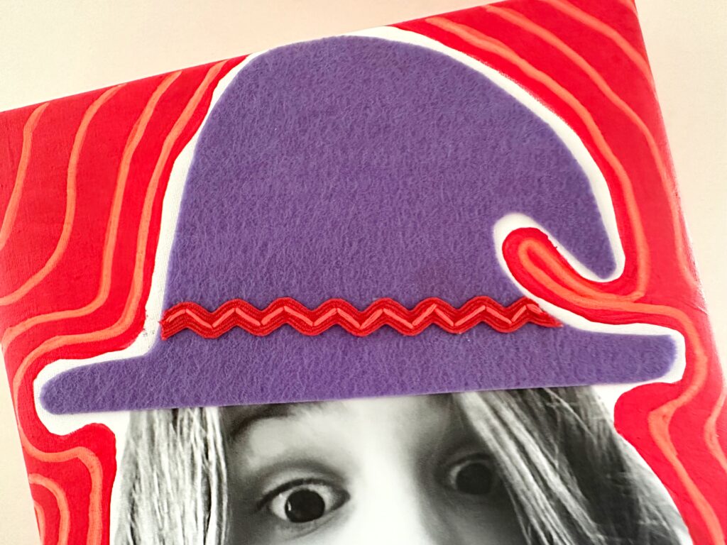 image of mixed media art with a big purple witch hat in felt with embroidered embellishments in red