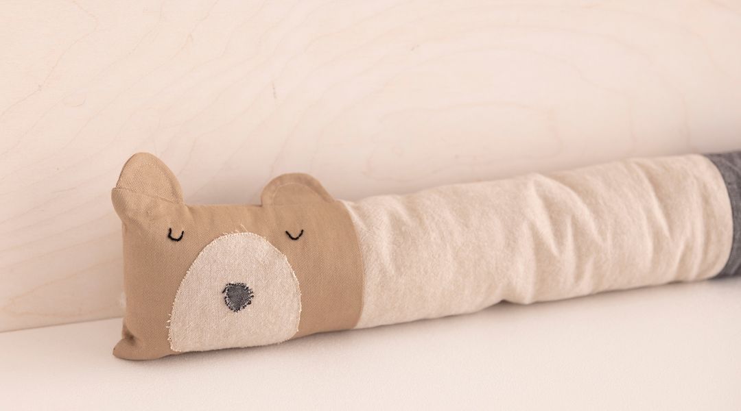image of a handmade stuffed bear that is used to stop drafts under doors