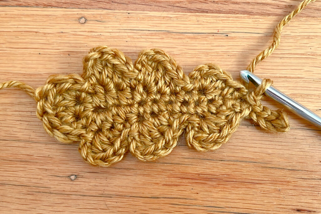 image of a golden yellow crocheted oak leaf